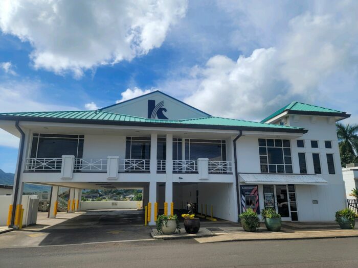 Lihue branch, two story building with a sea foam green roof and a blue "K" logo in front.